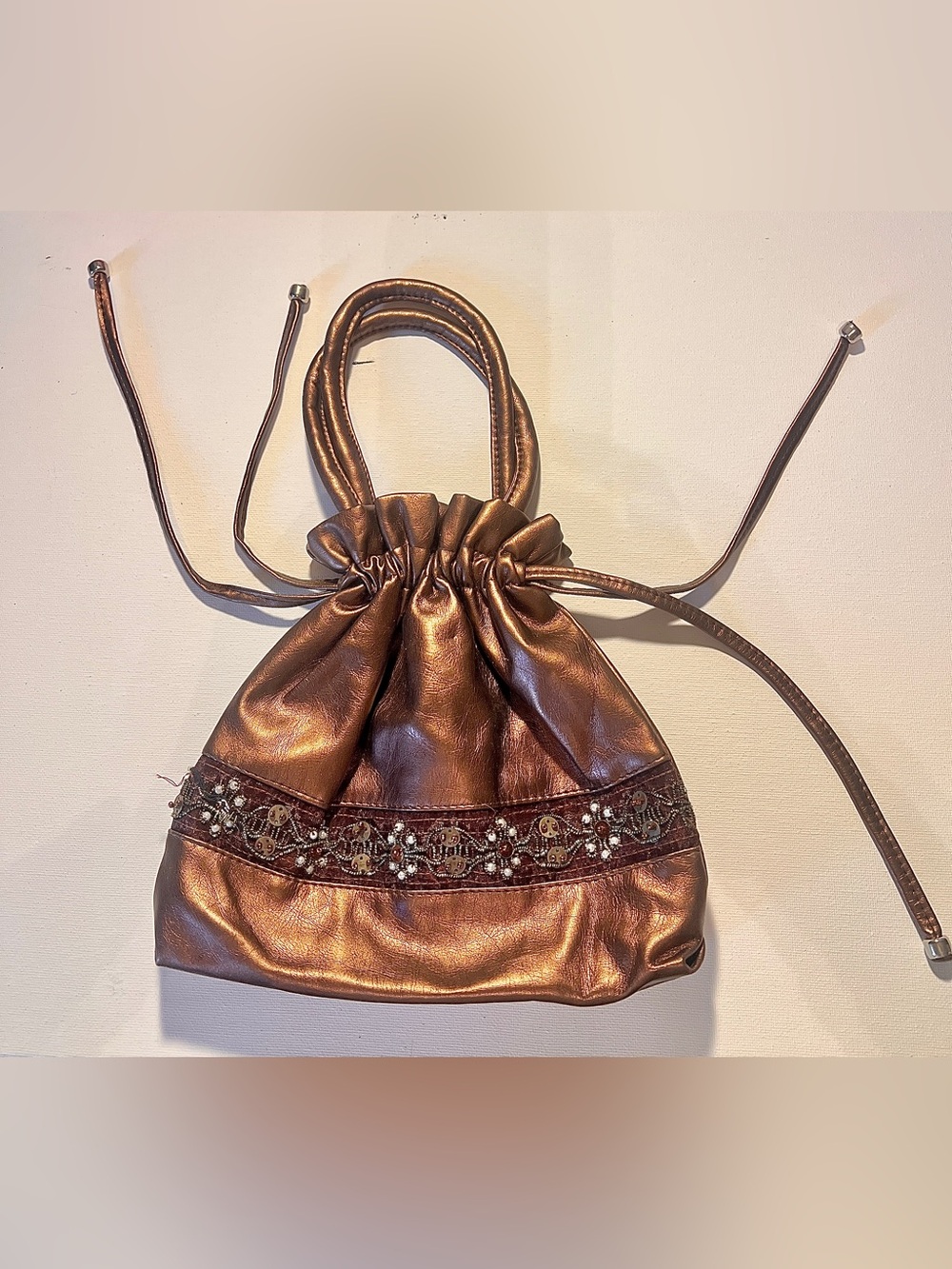 Metallic Bronze Drawstring Bucket Bag with Embellished Trim